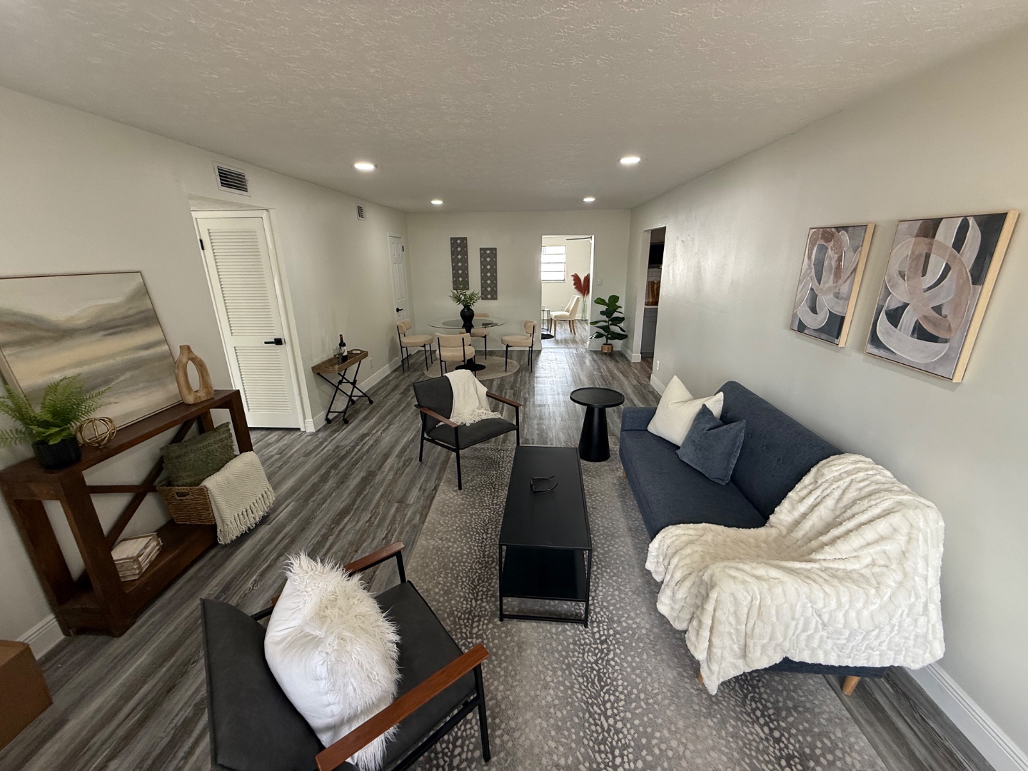 Open-plan living and dining with new vinyl plank flooring and fresh paint — Newtown CT